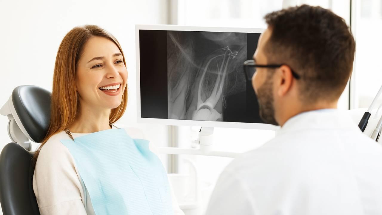 Dentist explaining how long for root canal to heal to a patient